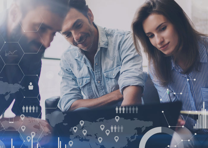 3 people looking at a computer screen, while smiling